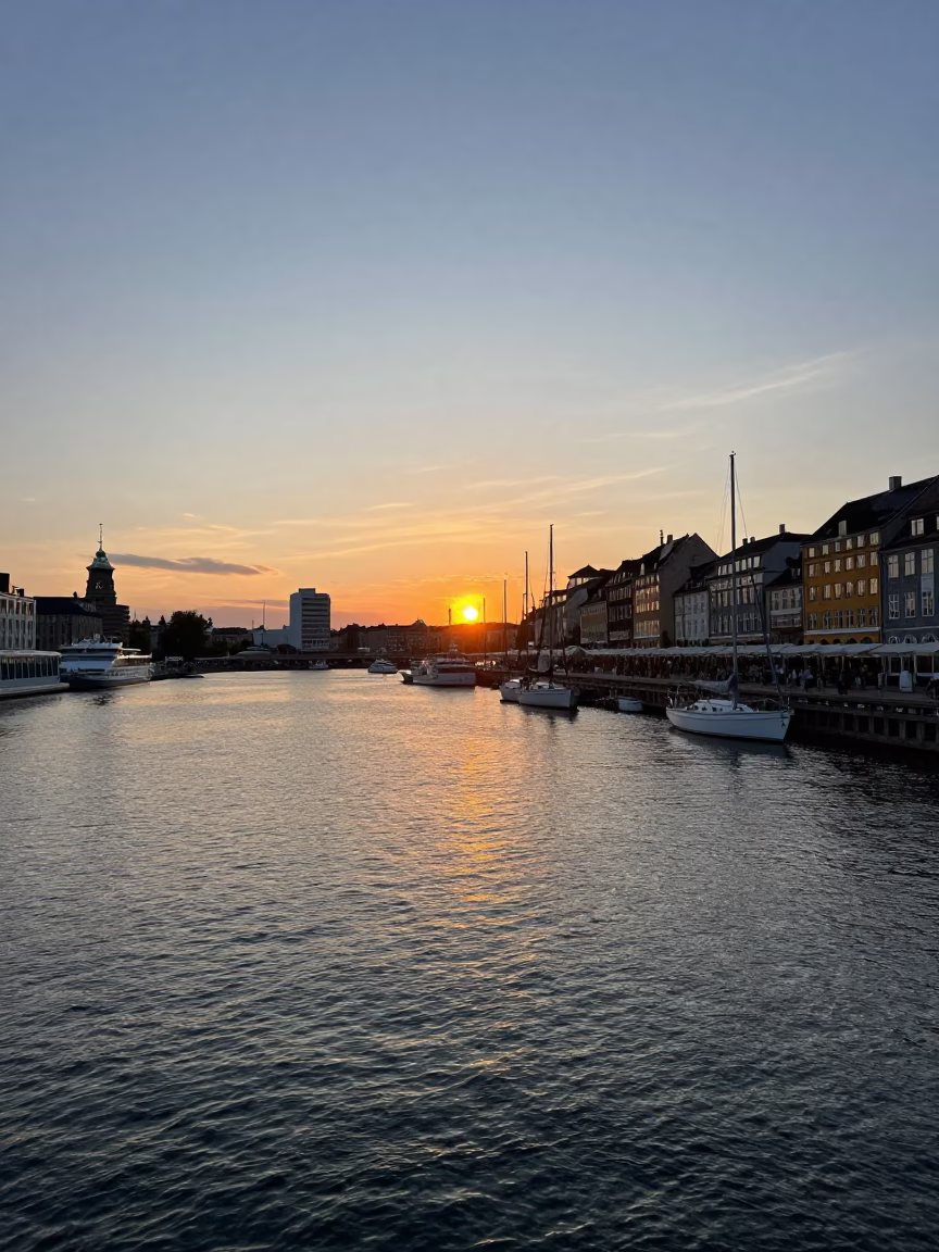 Copenhagen Harbor Sunset View with Sailing Boats and City Skyline in in Copenhagen, Denmark