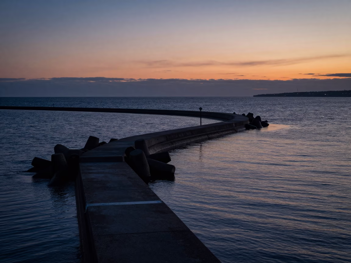 Copenhagen Harbor Twilight Breakwater Curve Leading to Lonely Harbor Beacon in in Copenhagen, Denmark