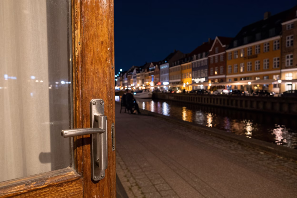 Copenhagen Night Street Scene with Brushed Steel Handle and Coat Brush Near Nyhavn Canal in in Copenhagen, Denmark
