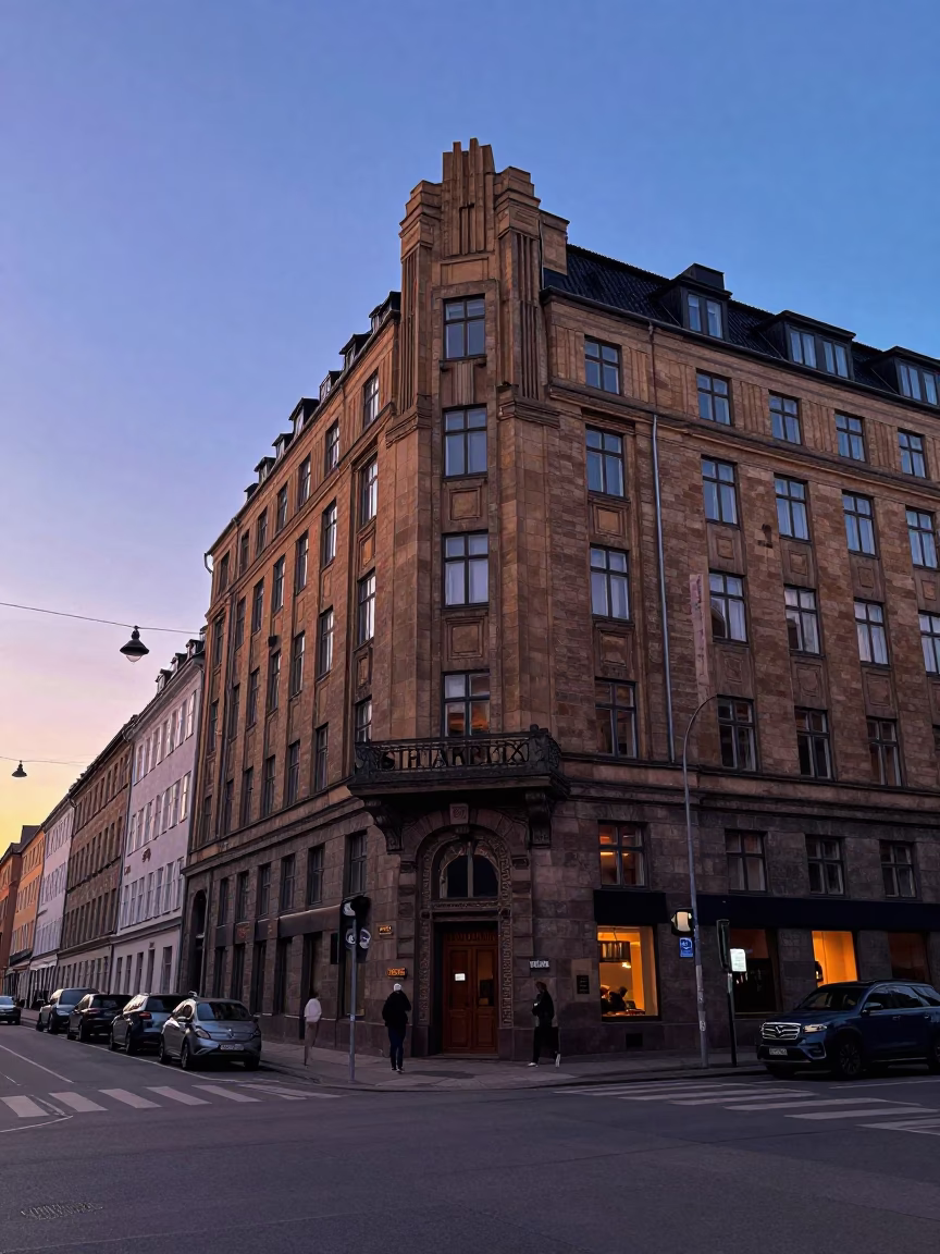 Copenhagen street scene at dusk with art deco hotel facade and local pedestrians in in Copenhagen, Denmark