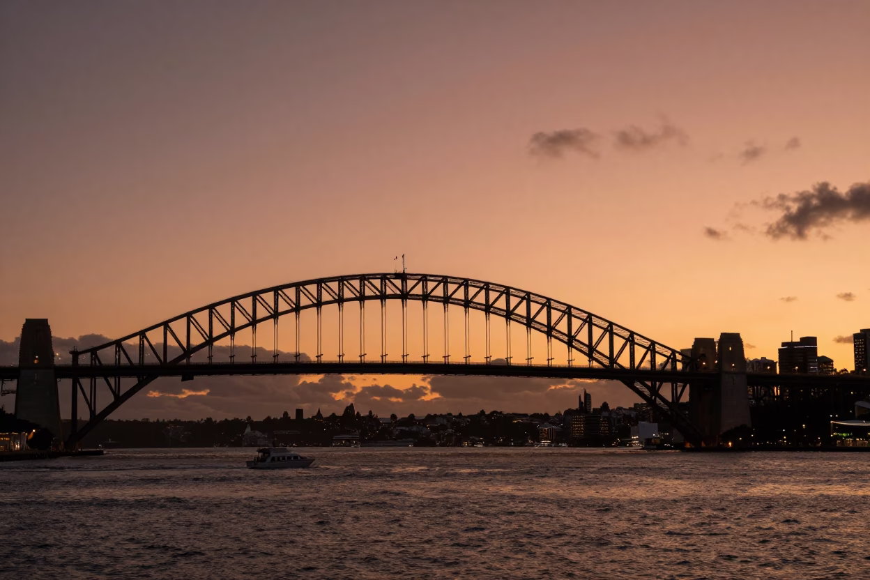 Copper Dusk Light on Auckland Harbour Bridge and Coastal Wind Twisted Cedar Trees in in Auckland, New Zealand