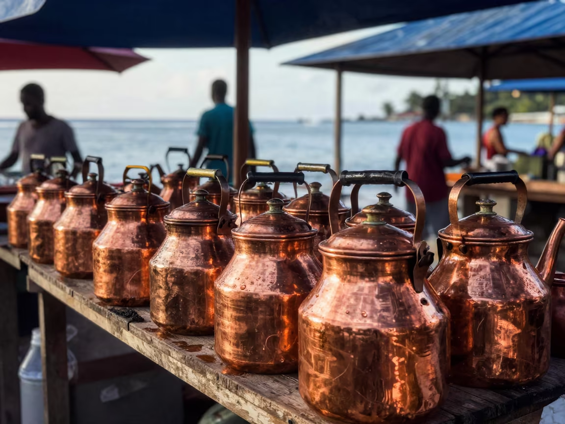 Copper Kettles Reflecting Passersby in Victoria in at a market stall in Victoria Seychelles