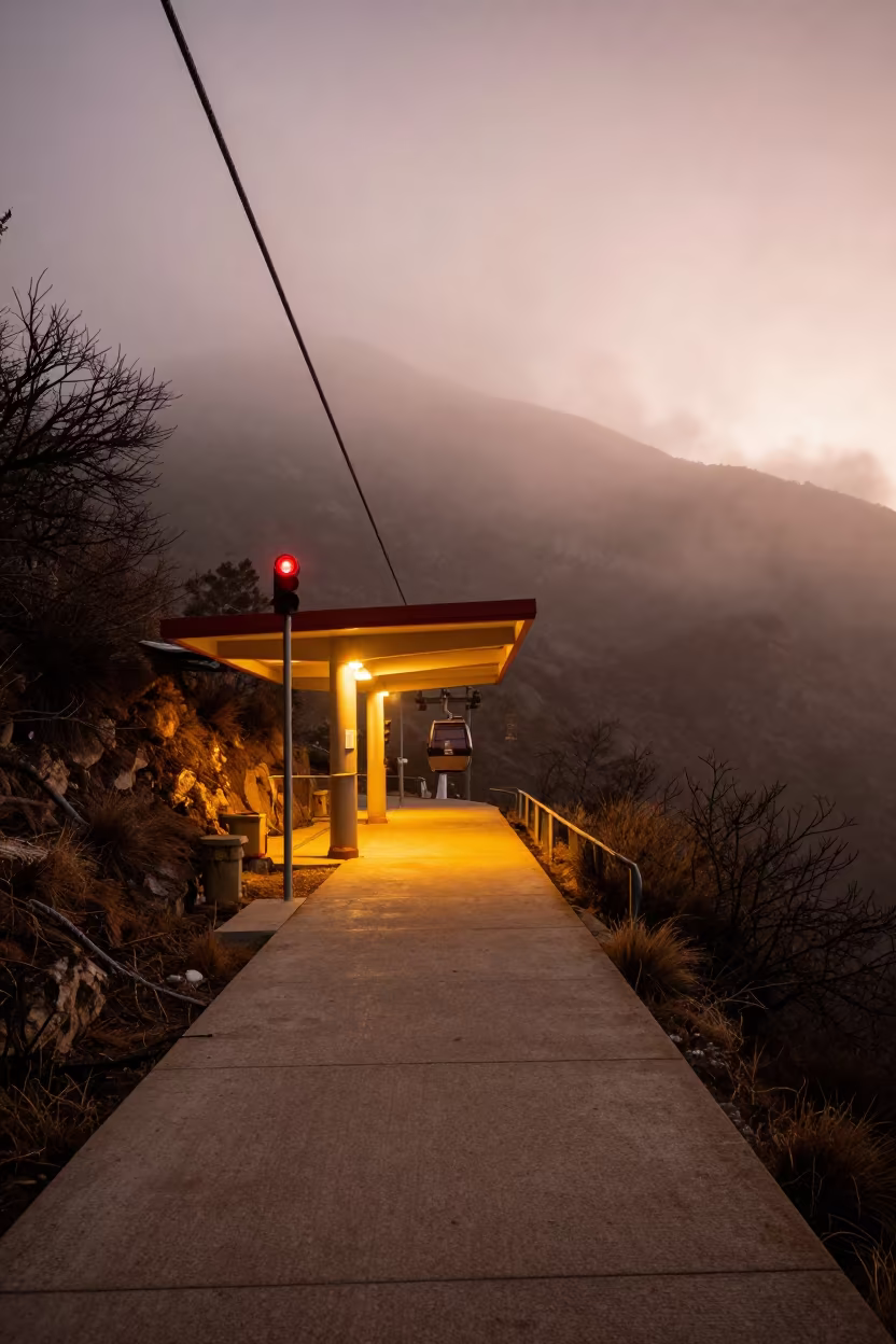 Copper Lit Cable Car Station in Winter Mist in along a switchback approach near Ensenada