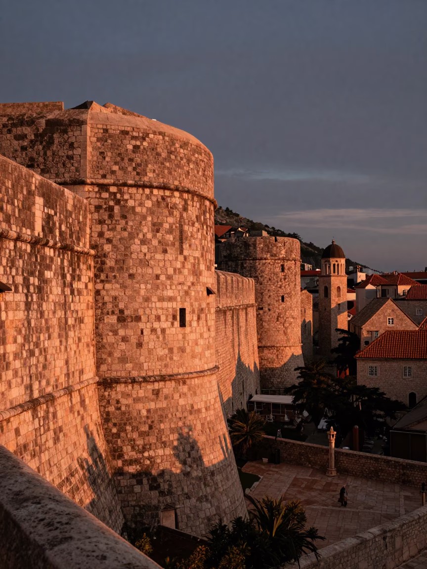 Copper-toned dusk light on historic stone walls and street corner in Dubrovnik Croatia in in Dubrovnik, Croatia