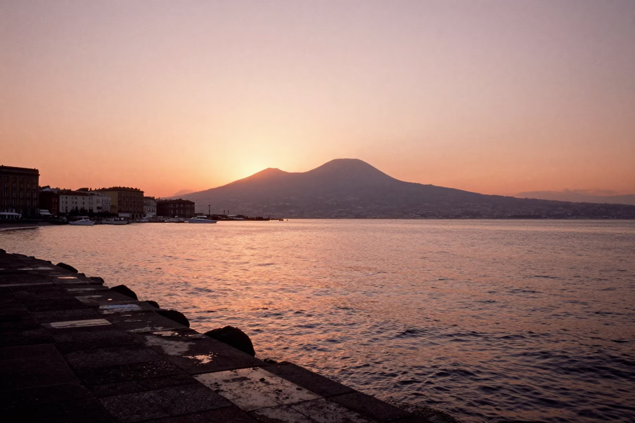 Copper-toned dusk light over Naples Italy historic port and Vesuvius horizon in in Naples, Italy