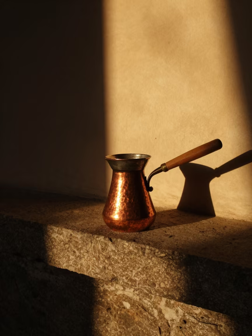 Copper Turkish Mocha Pot on Stone Ledge Sunset in on a stone ledge in Zabrze
