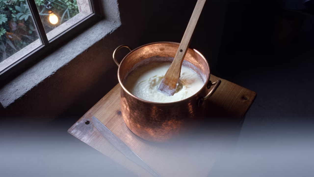 Copper Vat Stirring Curds Above Fog in on a wooden workbench in Aguascalientes