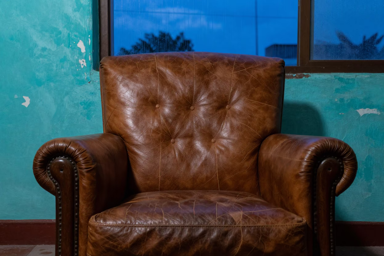 Cracked Leather Armchair Detail in Aguascalientes Twilight in against weathered turquoise paint in Aguascalientes