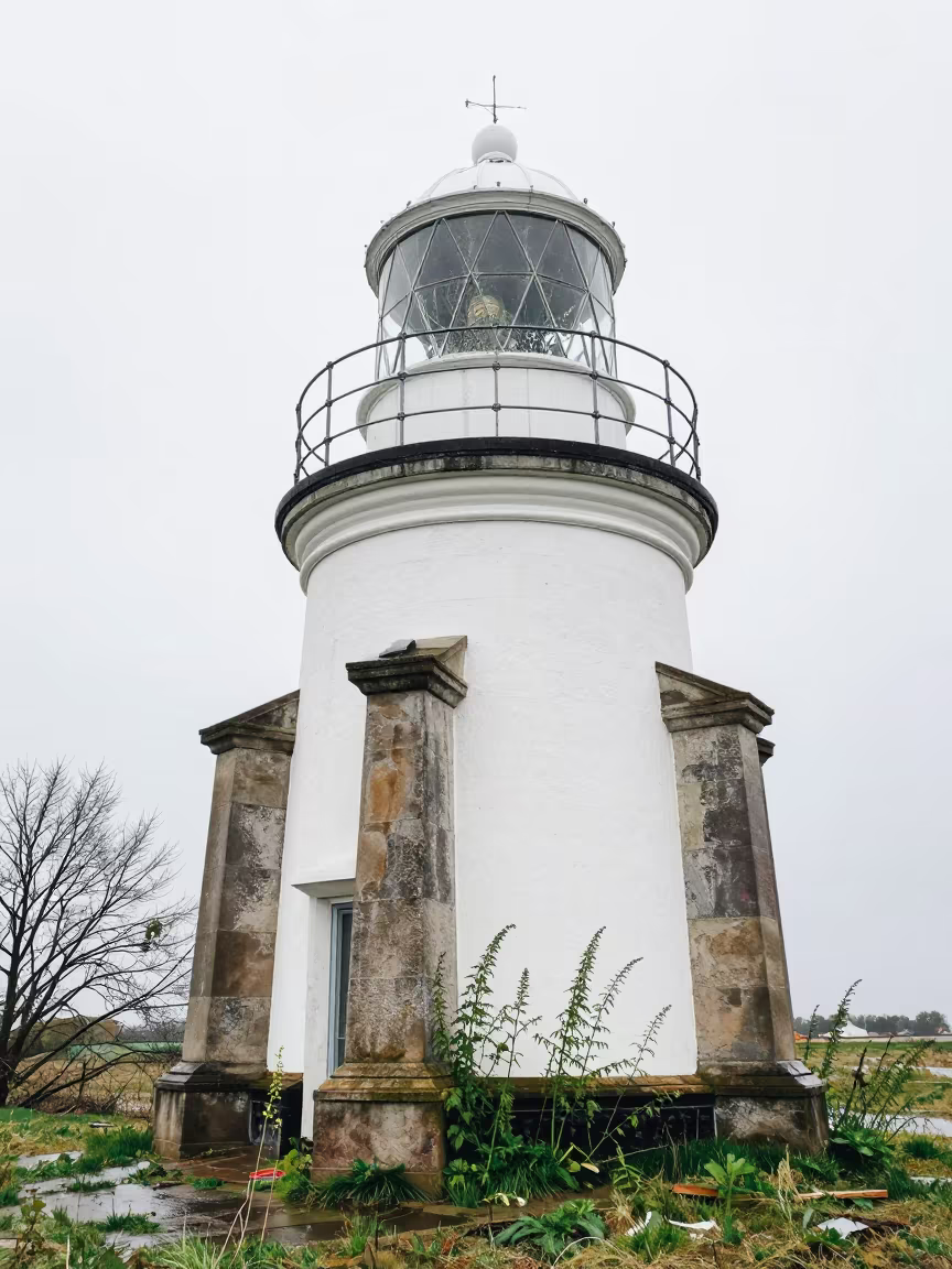 Cracked Lens Abandoned Lighthouse Denmark Ruins in among toppled columns and nettles in Denmark