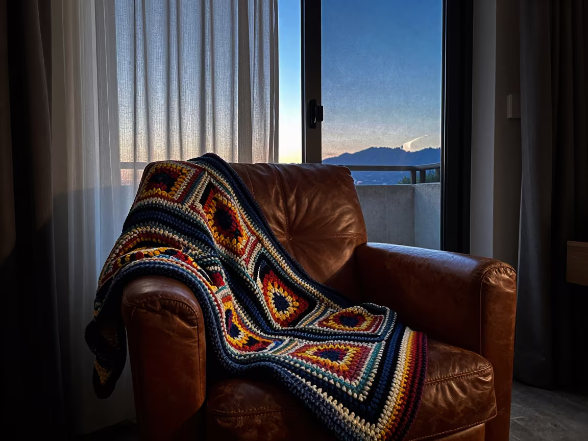 Crochet Blanket Dawn Night Sky Split in on a worn leather armchair in Barakaldo