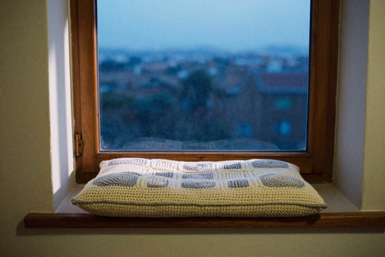 Crocheted Cushion on Window Seat Evening Light in on a window seat in Russeifa