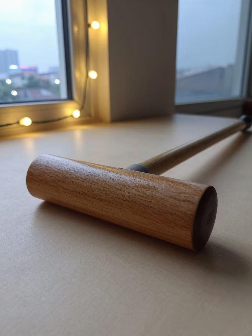 Croquet Mallet on Sunlit Shelf in Hyderabad Playroom in on a wooden workbench in Hyderabad
