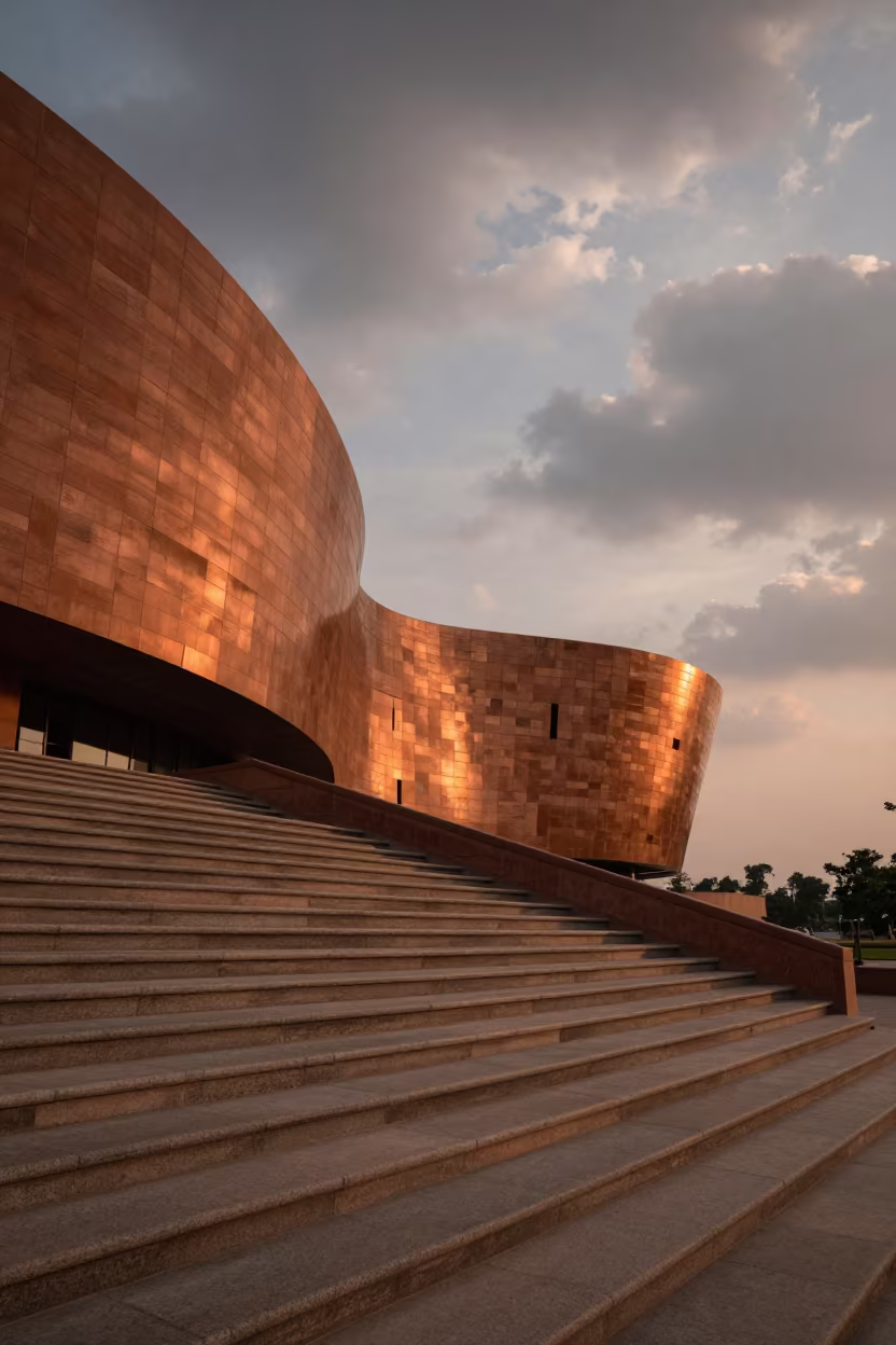 Curved Museum Facade in Amber Delhi Sunset Light in at the base of a monumental staircase near Delhi
