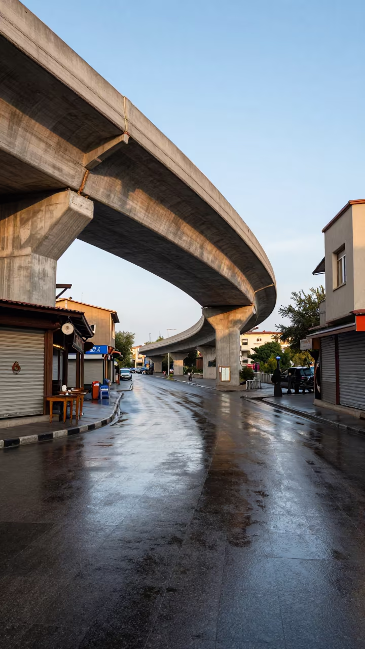 Curved Overpass Ramp Above Shuttered Sivas Shops in outside a corner cafe in Sivas