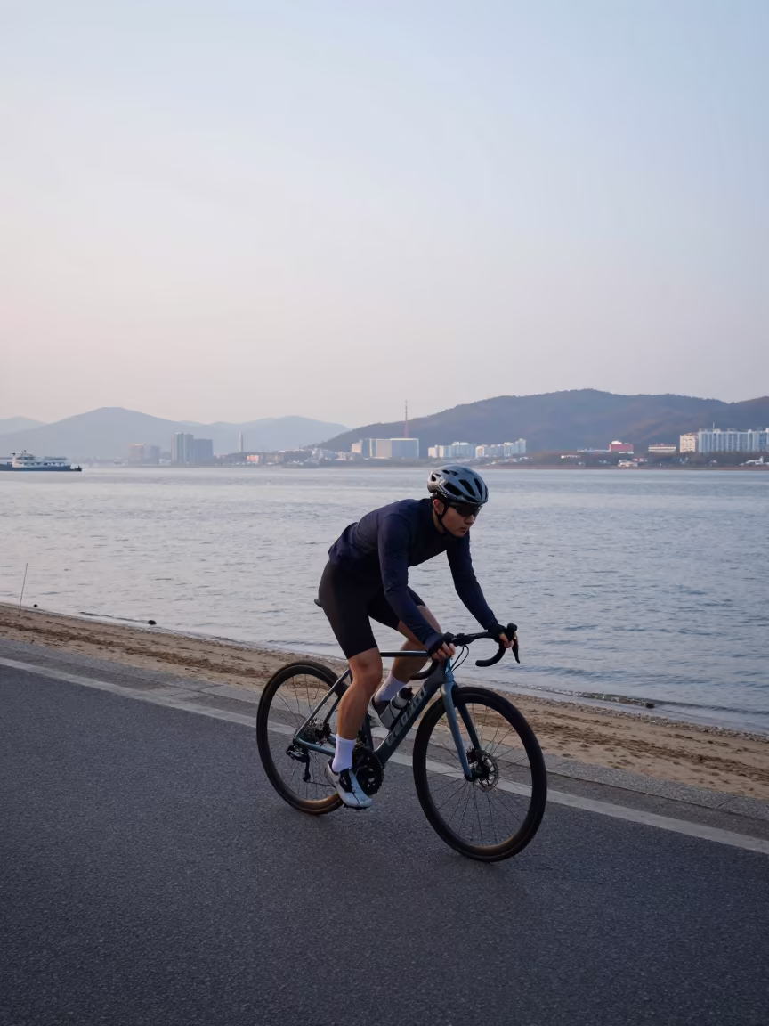 Cyclist at Busan Harbor Dawn in along a beach near Busan