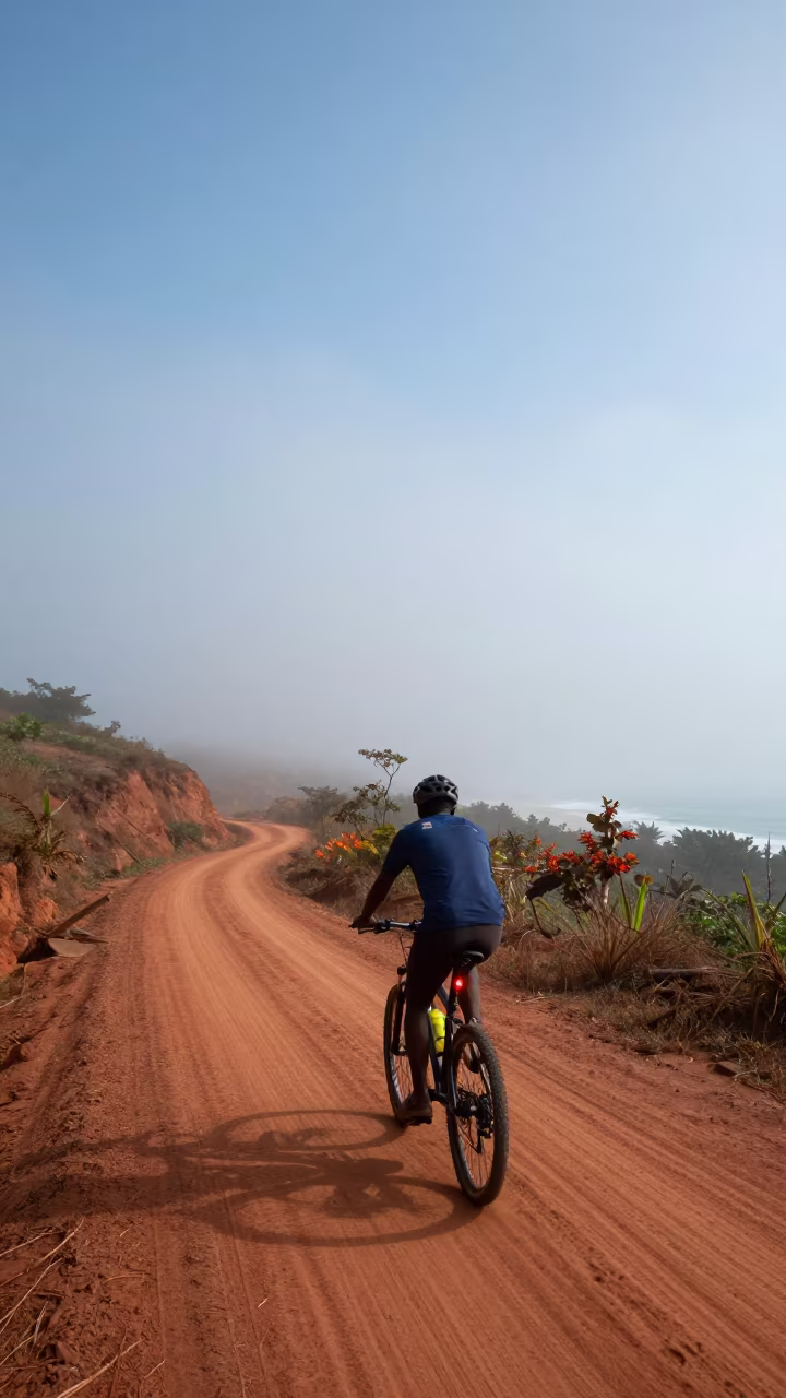 Cyclist Light Trail on Foggy Mountain Path in on a mountain path near Conakry