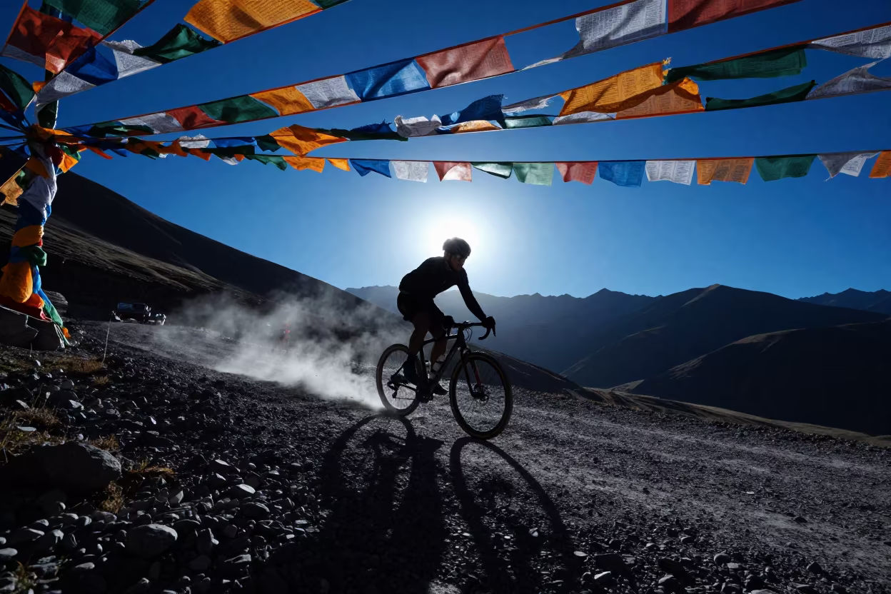 Cyclist Silhouette on Lhasa Mountain Pass in along a high mountain pass beneath prayer flags near Lhasa