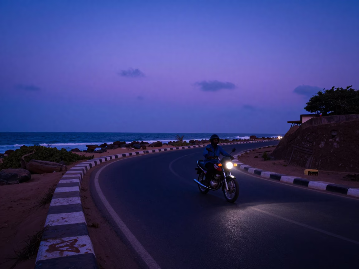 Dakar Senegal indigo twilight street scene with motorcycle on coastal highway in in Dakar, Senegal