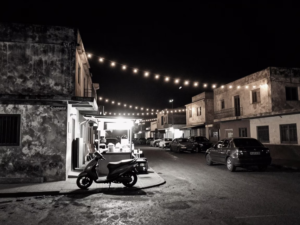 Dakar Senegal Night Street Scene With String Lights And Parked Scooter in in Dakar, Senegal