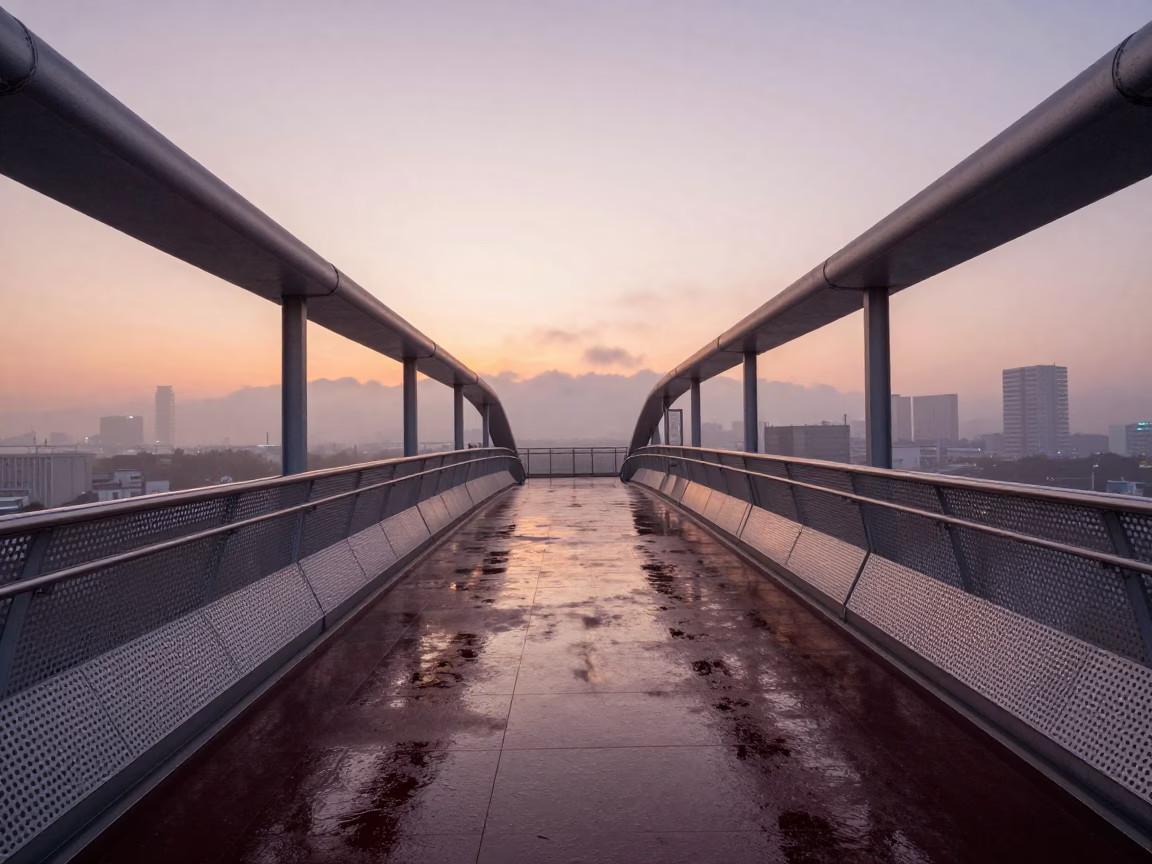 Dawn in Osaka Japan Wet Perforated Metal Pedestrian Overpass and City Lights in in Osaka, Japan