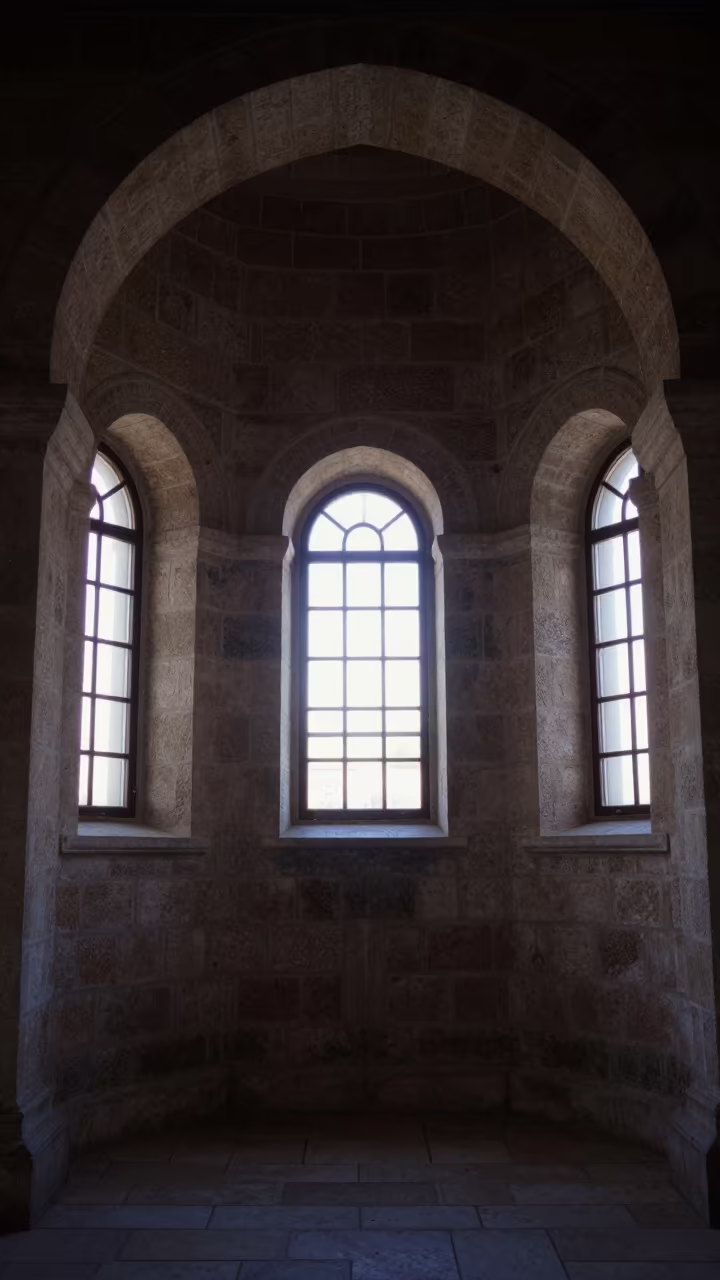 Dawn light falls across stone nave walls in inside a candlelit nave in Nazareth