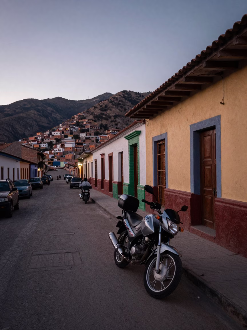 Dawn light illuminates La Paz Bolivia street scene with motorcycle parked near Andean architecture in in La Paz, Bolivia