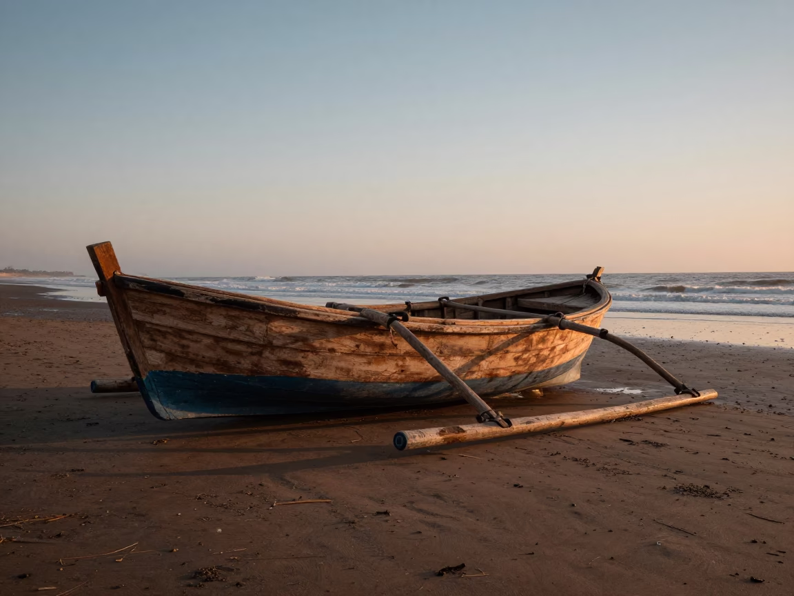 Dawn light on a wooden fishing boat with outrigger in Casablanca Morocco in in Casablanca, Morocco