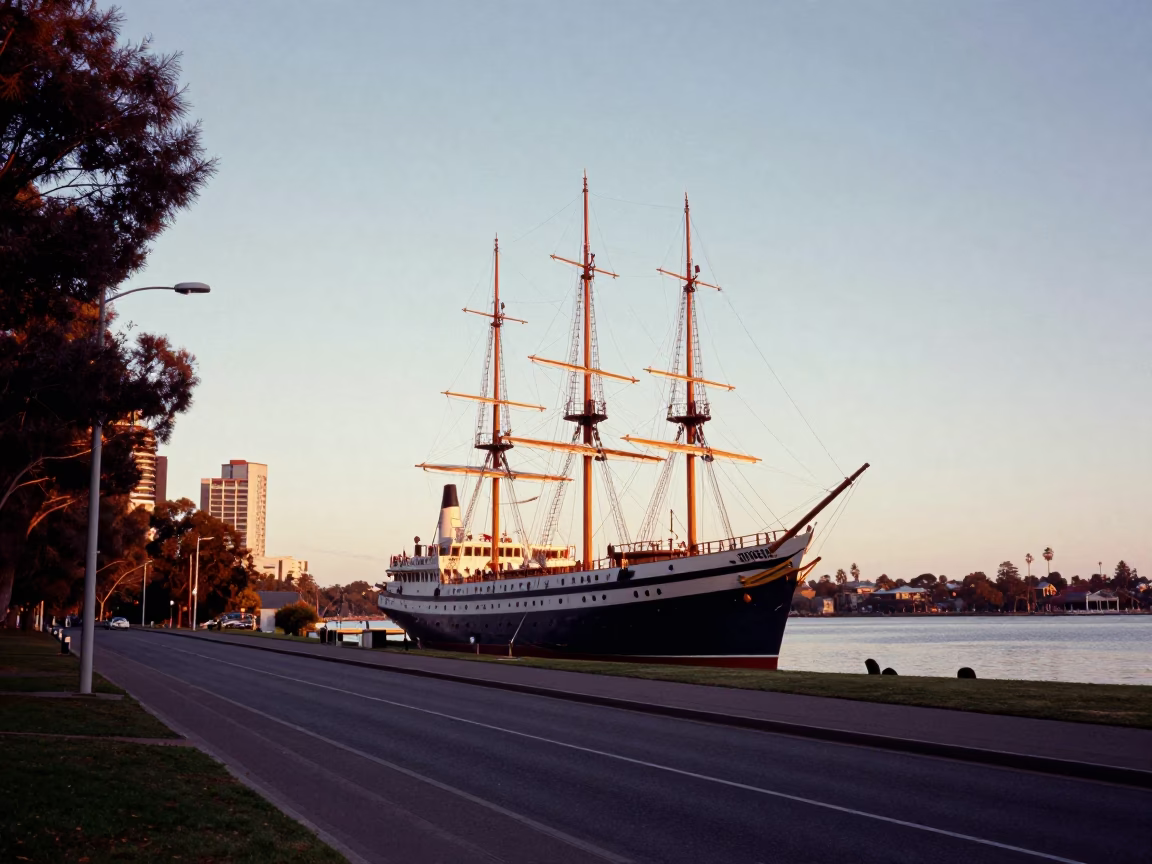 Dawn light on Adelaide Park Lands street with tall ship and bell in in Adelaide, South Australia, Australia