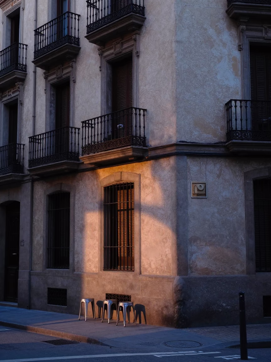 Dawn Light on Barcelona Street Corner with Metal Stools and Ceramic Detail in in Barcelona, Spain