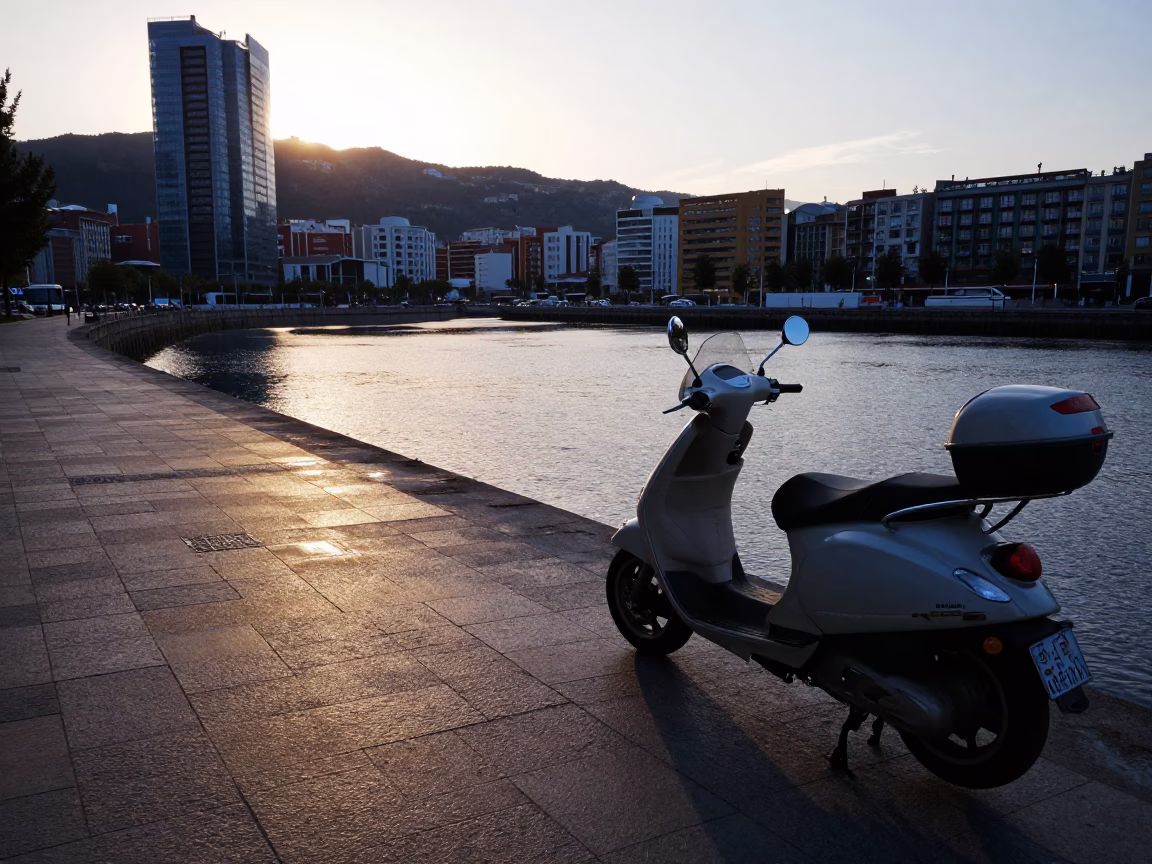 Dawn Light on Bilbao Harbor Promenade with Parked Scooter and Coastal Architecture in in Bilbao, Spain