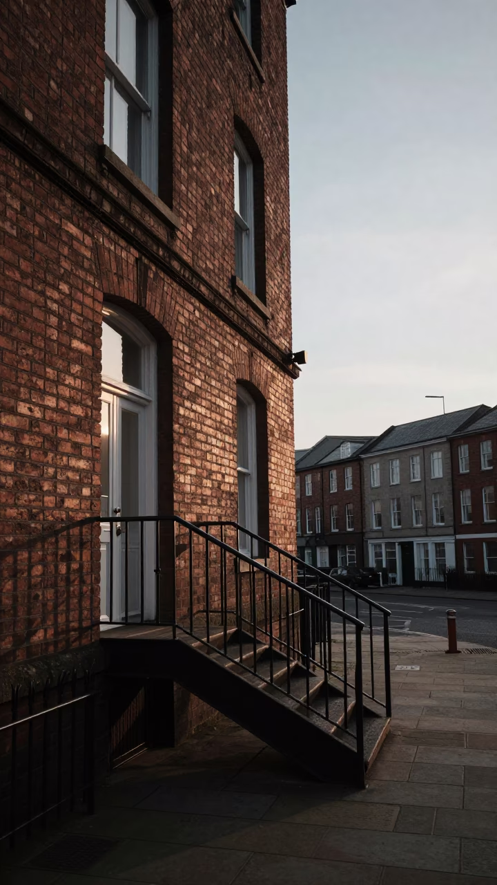 Dawn Light on Brick Facade in Liverpool Before Sunrise with Stair Rail in in Liverpool, United Kingdom