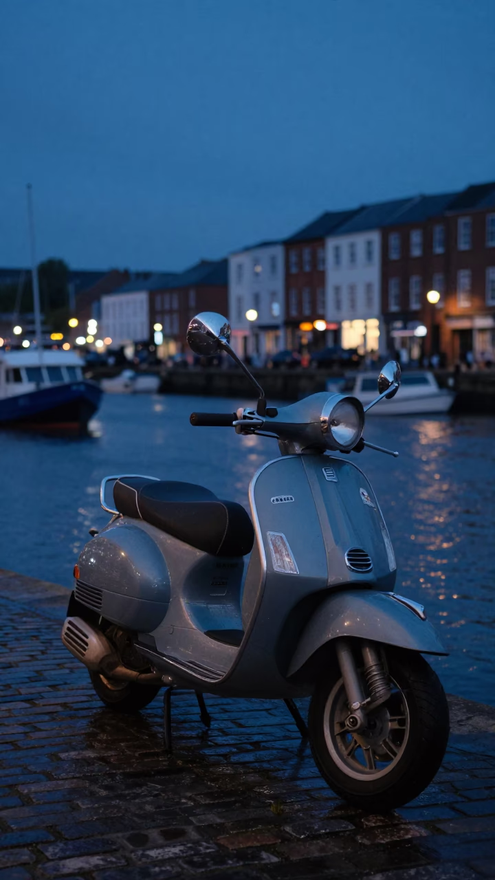 Dawn Light on Bristol Harbor Promenade with Parked Scooter and City Skyline in in Bristol, United Kingdom
