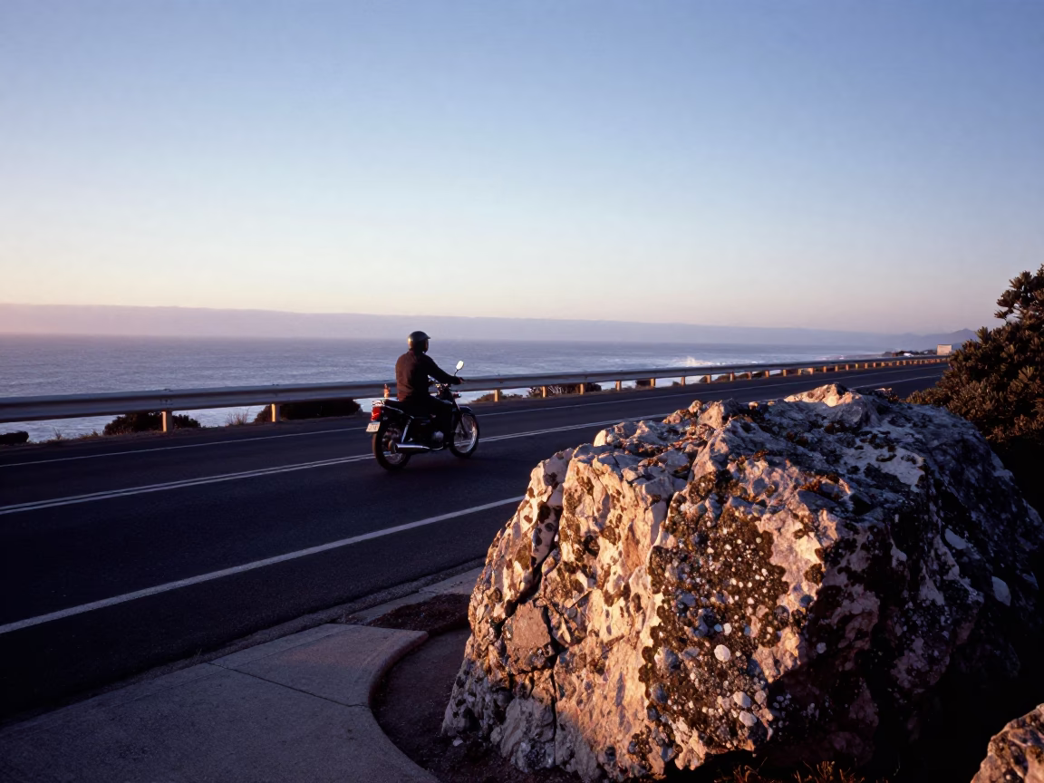 Dawn Light on Cape Town Coastal Highway Motorcycle and Rock Face in in Cape Town, South Africa