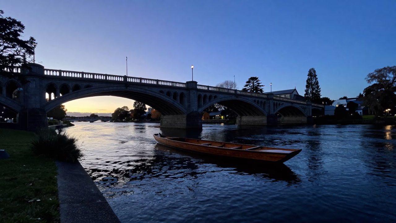 Dawn Light on Christchurch Avon River with Punt Under Gothic Bridge in in Christchurch, New Zealand