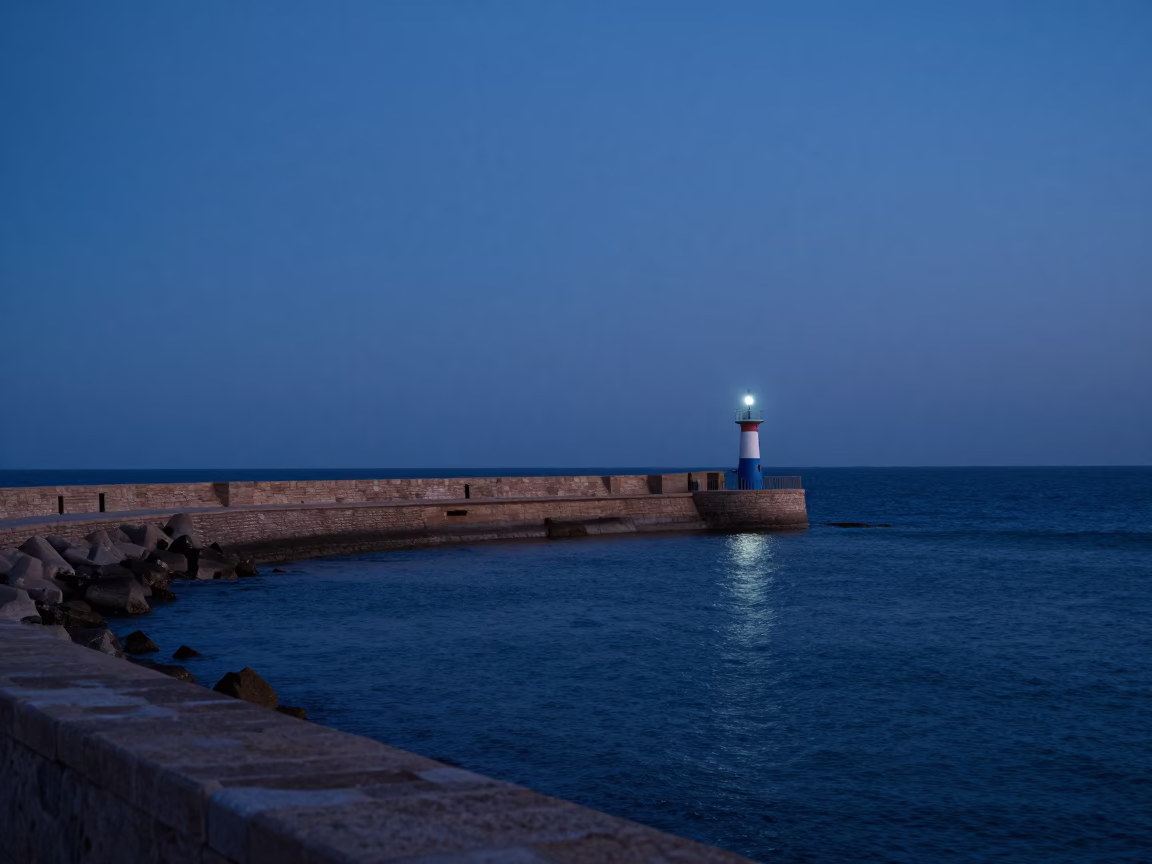 Dawn Light on Essaouira Breakwater with Harbor Beacon and Traditional Tea Service in in Essaouira, Morocco