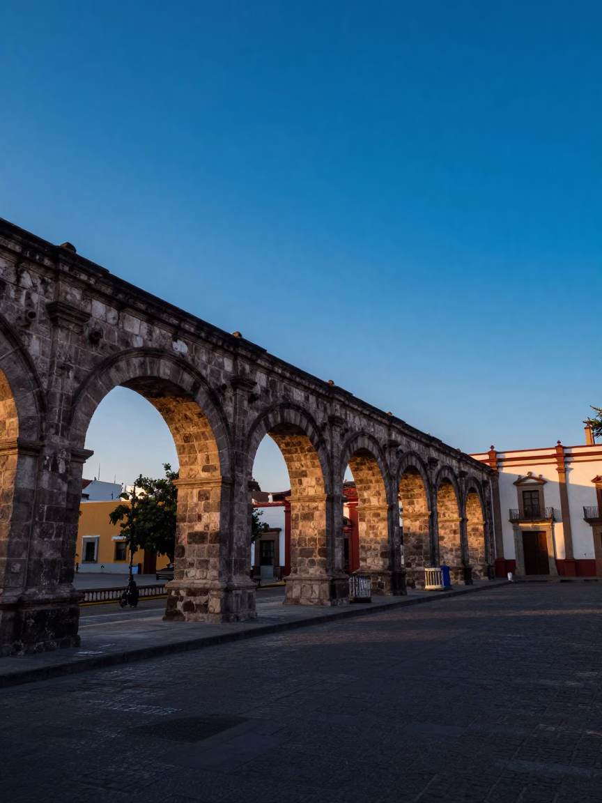 Dawn light on Guadalajara colonial arches and quiet street scene before sunrise in in Guadalajara, Mexico
