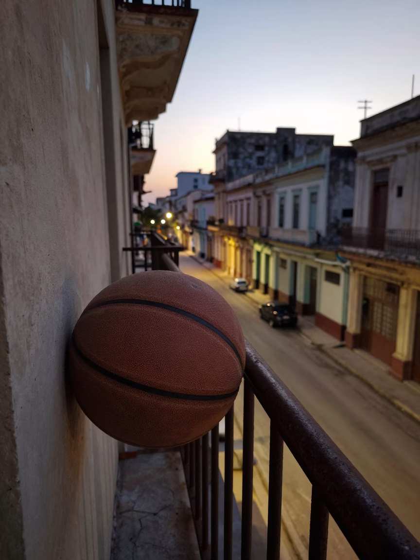 Dawn Light on Havana Balcony with Old Leather Basketball and Deck Chair in in Havana, Cuba
