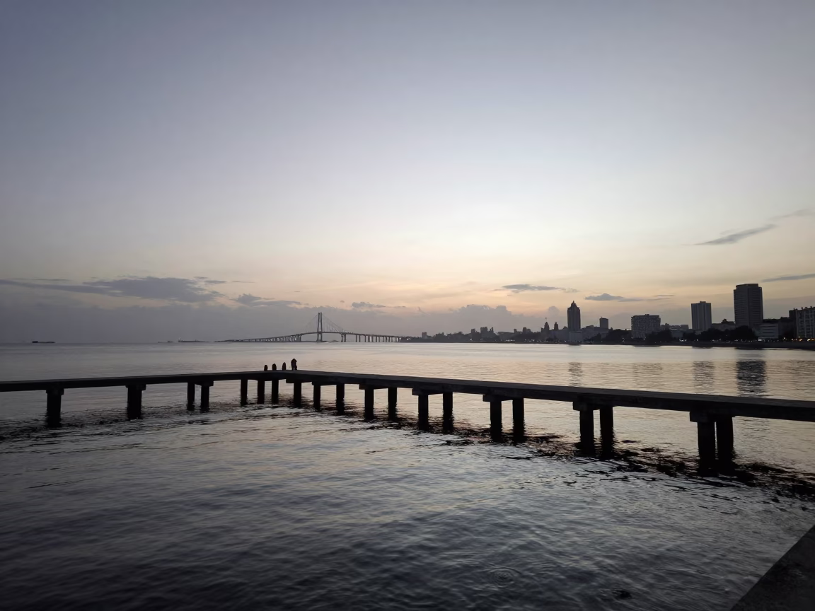 Dawn light on Havana bay with bridge pier and calm water before sunrise in in Havana, Cuba