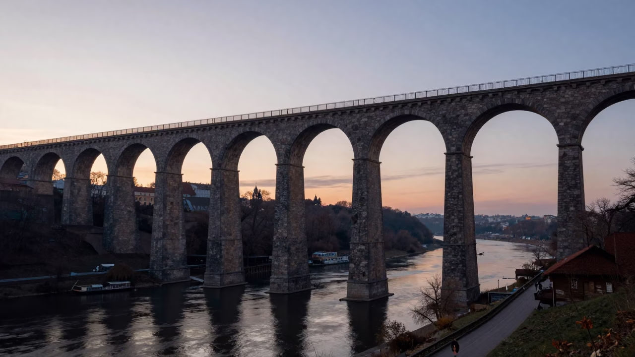 Dawn Light on Historic Krakow Viaduct Arches and Urban Riverbank in in Krakow, Poland