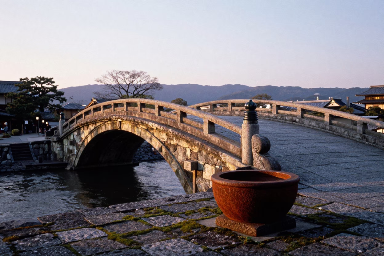 Dawn Light on Kyoto Stone Bridge with Rusty Basin and Traditional Architecture in in Kyoto, Japan