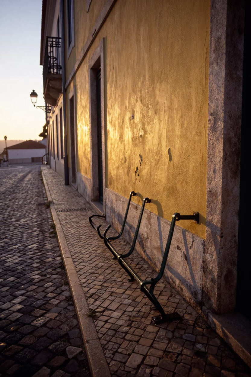 Dawn Light on Lisbon Cobblestones with Vintage Peg Rails and Street Details in in Lisbon, Portugal