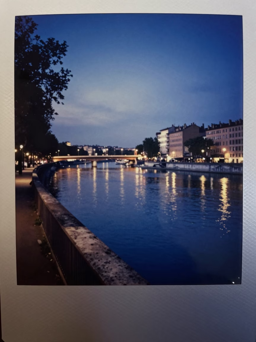 Dawn light on Lyon riverbank with overpass taillights and wet asphalt in in Lyon, France