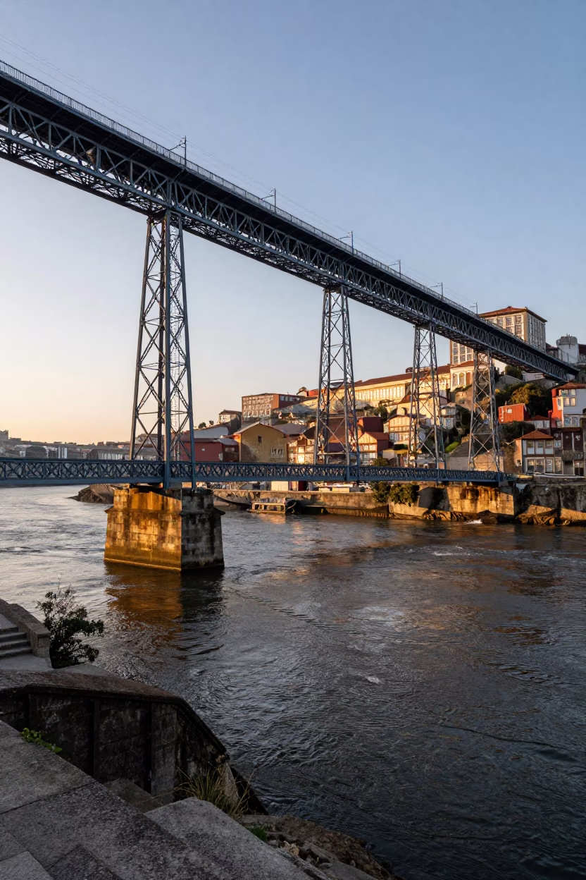 Dawn Light on Porto Stone Bridge Pier Cutting Through Douro River Brown Water Current in in Porto, Portugal