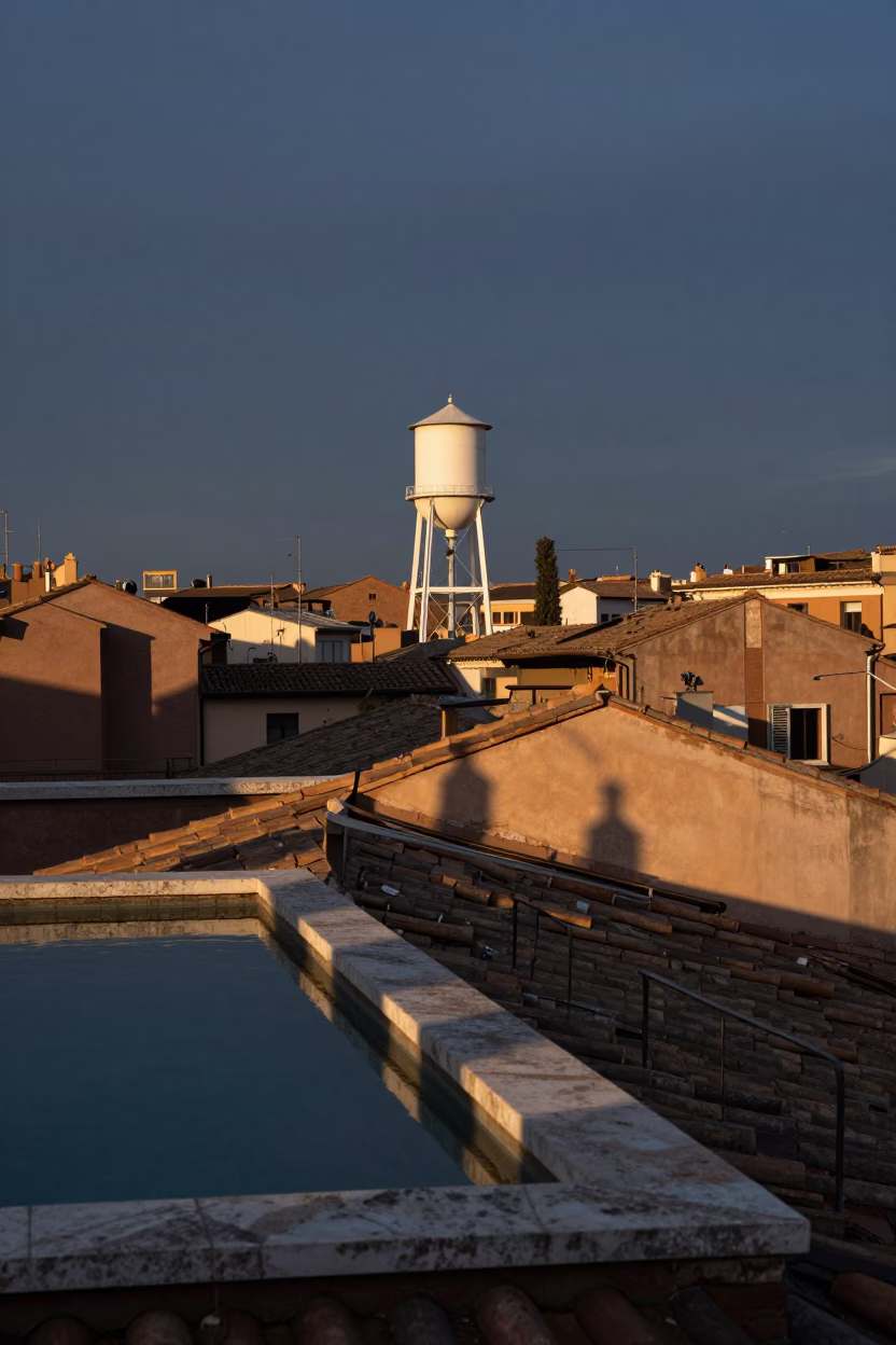 Dawn light on Roman rooftop terrace with water tower and espresso preparation in in Rome, Italy