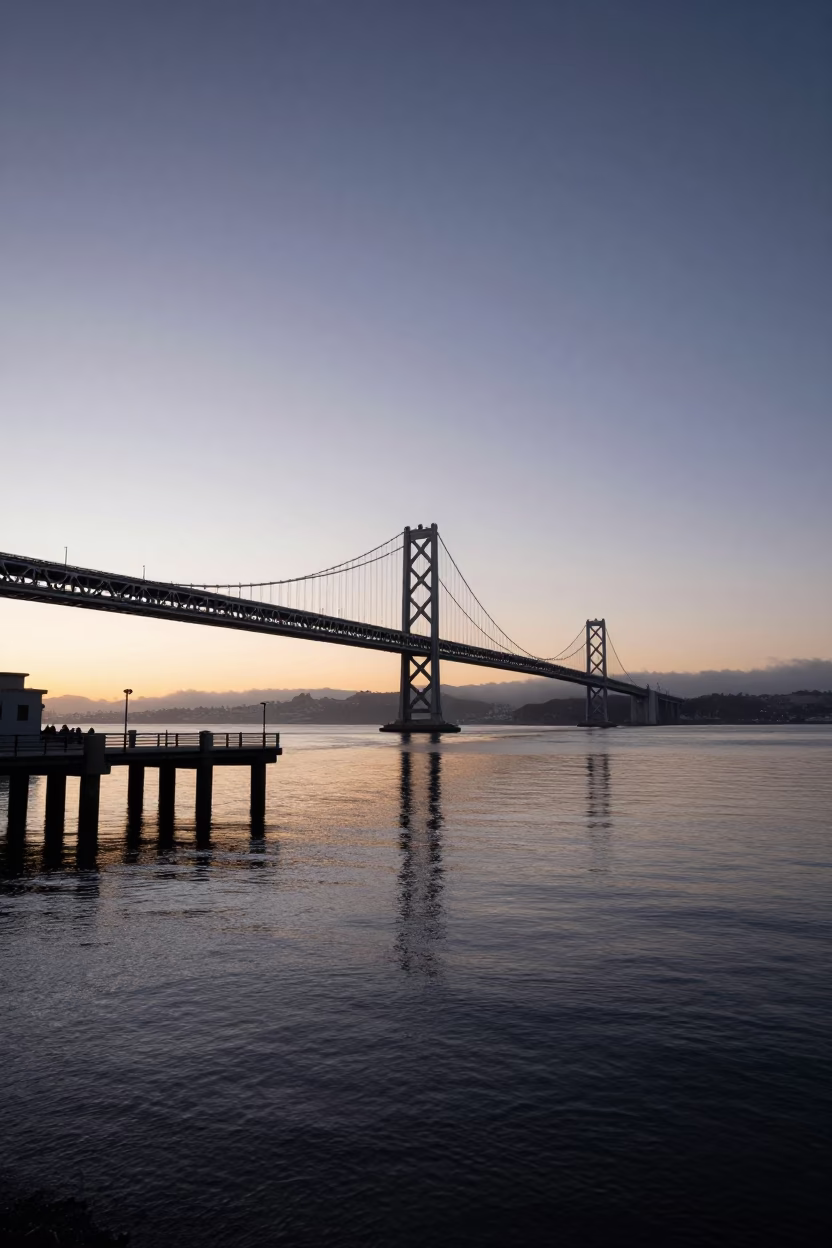 Dawn light on San Francisco Bay bridge pier and calm water before sunrise in in San Francisco, California, United States