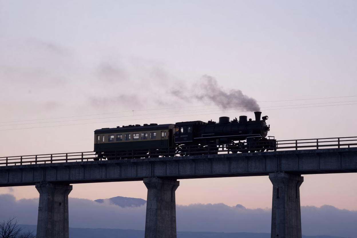 Dawn light on Sapporo railway viaduct with steam train crossing arches in in Sapporo, Japan