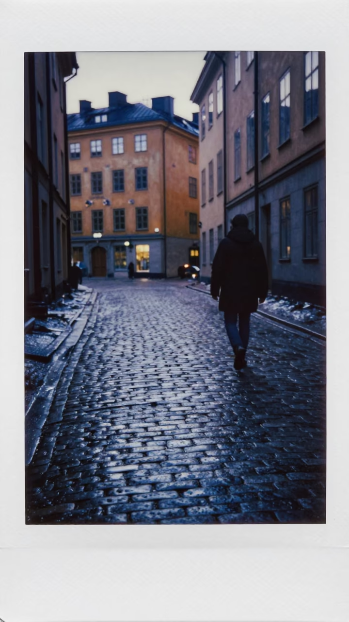 Dawn light on Stockholm cobblestones with condensation on metal rail and city architecture in in Stockholm, Sweden