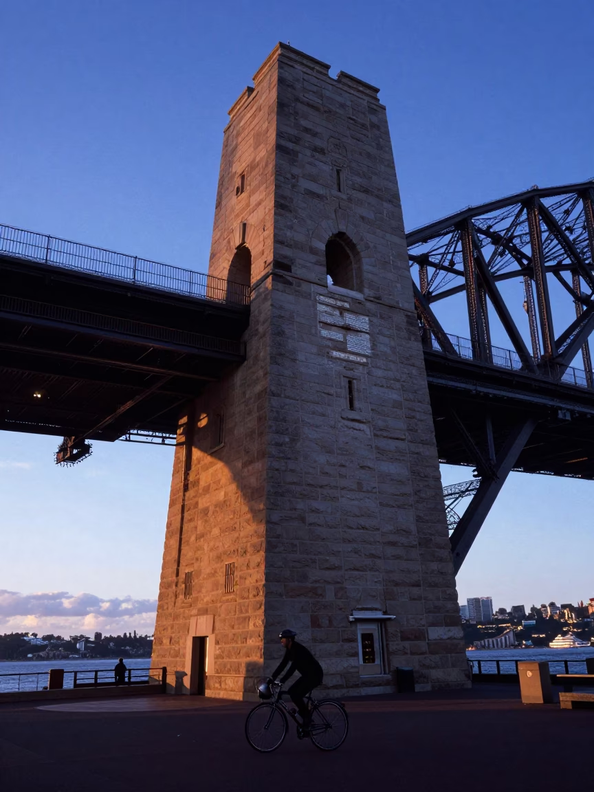 Dawn Light on Sydney Harbour Bridge Pylon with Cyclist and Coffee in in Sydney, New South Wales, Australia