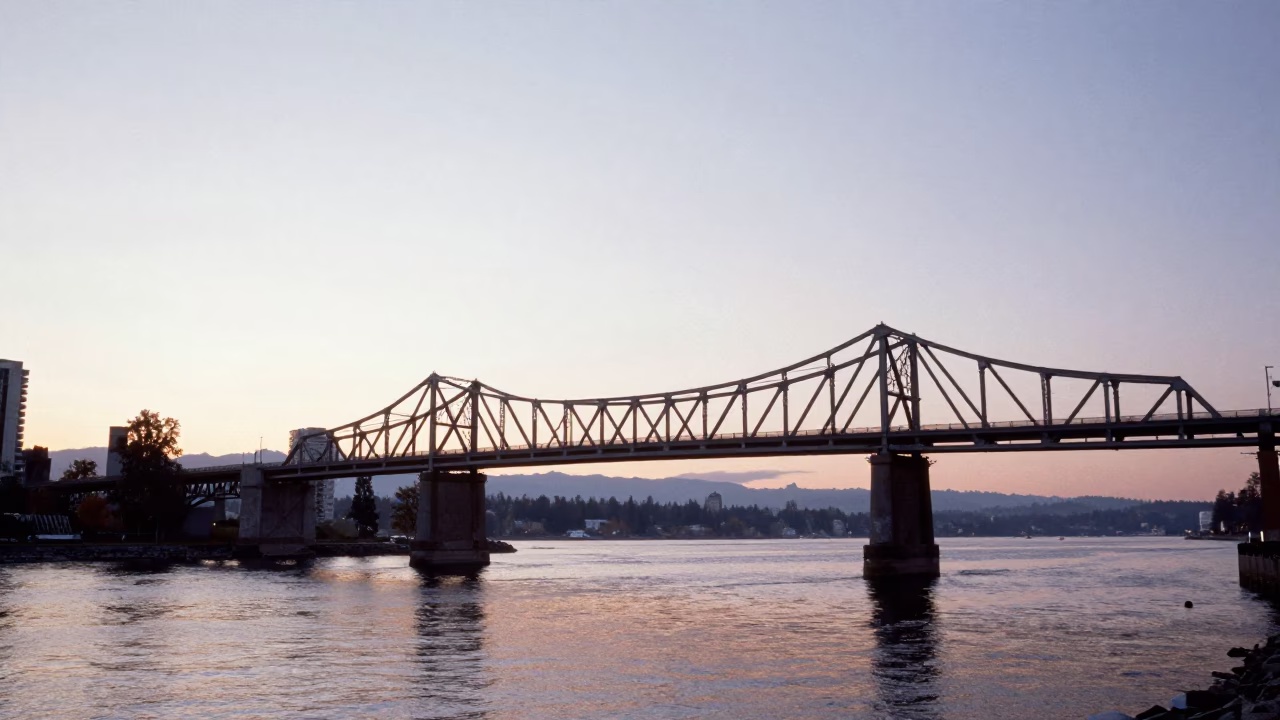 Dawn Light on Vancouver Waterfront with Iron Bridge and Maritime Activity in in Vancouver, British Columbia, Canada