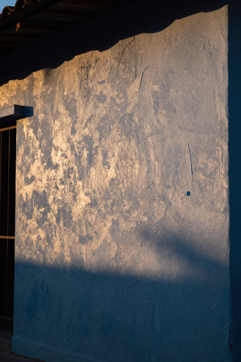 Dawn Light on Weathered Plaster Wall with Grease Sheen in Medellin Colombia in in Medellin, Colombia